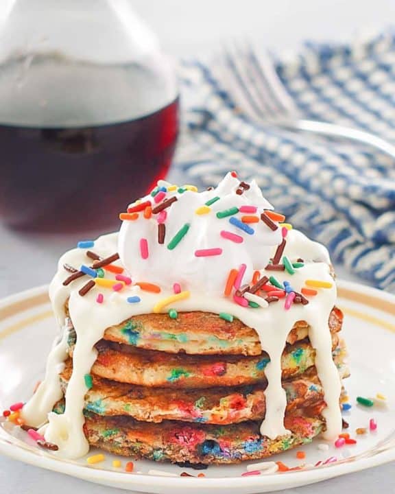 a stack of homemade IHOP cupcake pancakes with icing and syrup