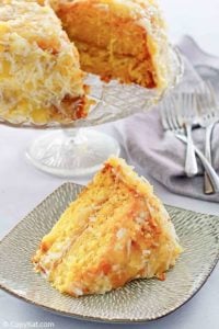 a slice of Mountain Dew Cake in front of the cake on a stand