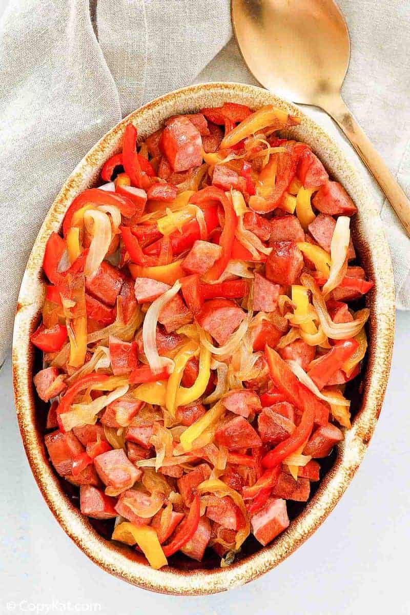 overhead view of smoked sausage and peppers in a serving dish