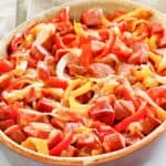 smoked sausage, peppers, and onions in a serving dish