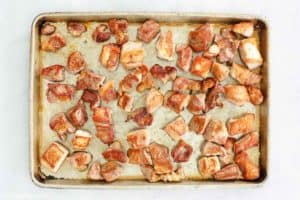 seared pork pieces on a baking sheet