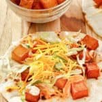 spicy potato taco with chipotle sauce, lettuce, and cheese
