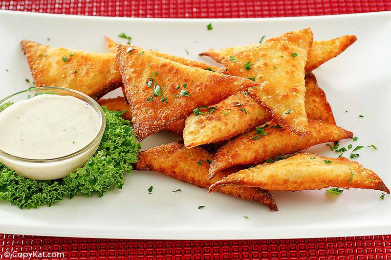 a platter of jalapeno popper wontons and dipping sauce