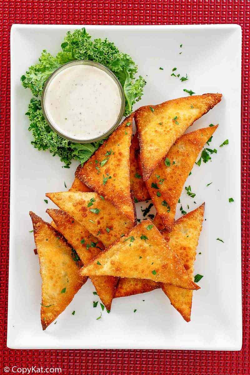 wonton jalapeno poppers and dip on a platter