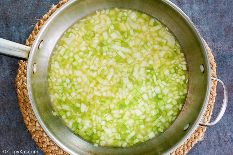 chopped onions, chopped celery, and chicken broth in a pan