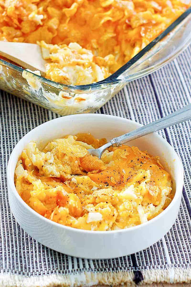 cheesy hashbrown potato casserole in a bowl and baking dish