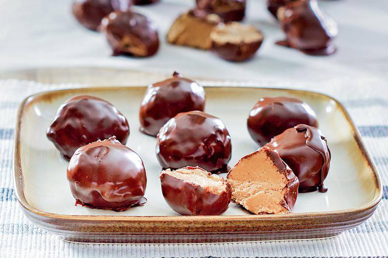 chocolate peanut butter balls on a square plate