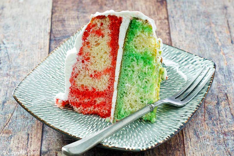 a slice of jello poke cake with cool whip frosting