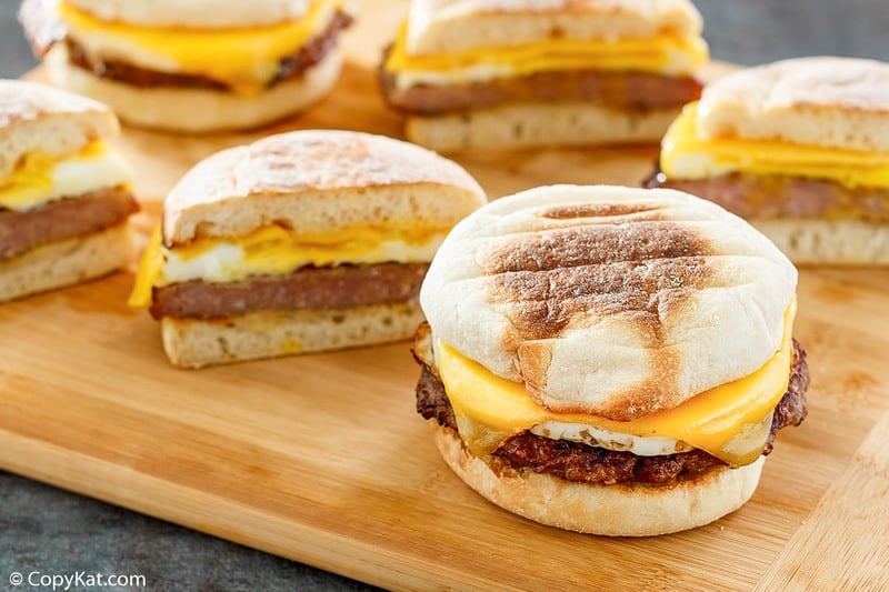 homemade McDonald's Sausage Egg McMuffin breakfast sandwiches on a wood board