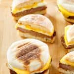 four homemade sausage, egg, and cheese English muffin breakfast sandwiches