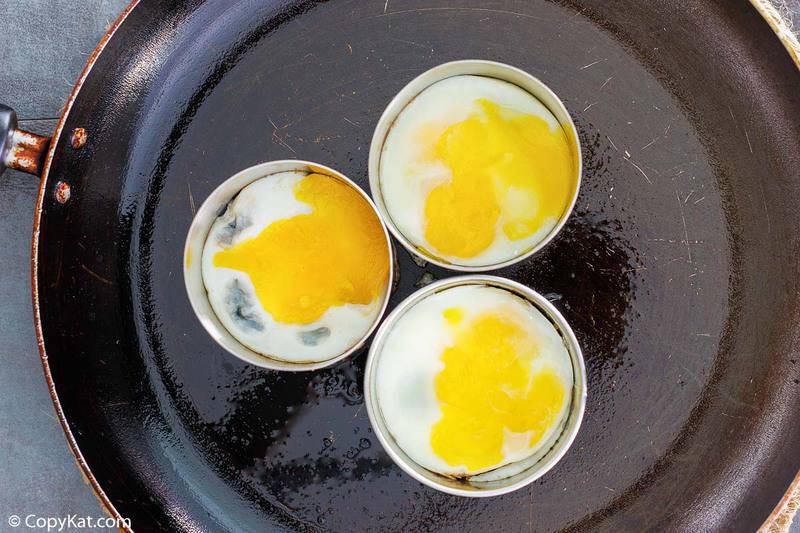 three fried egg rounds in a skillet