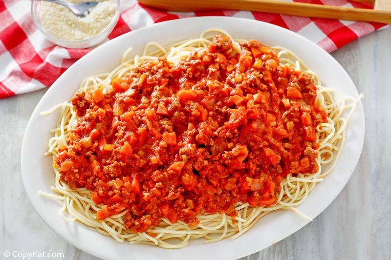 homemade Olive Garden Bolognese sauce and pasta on a platter