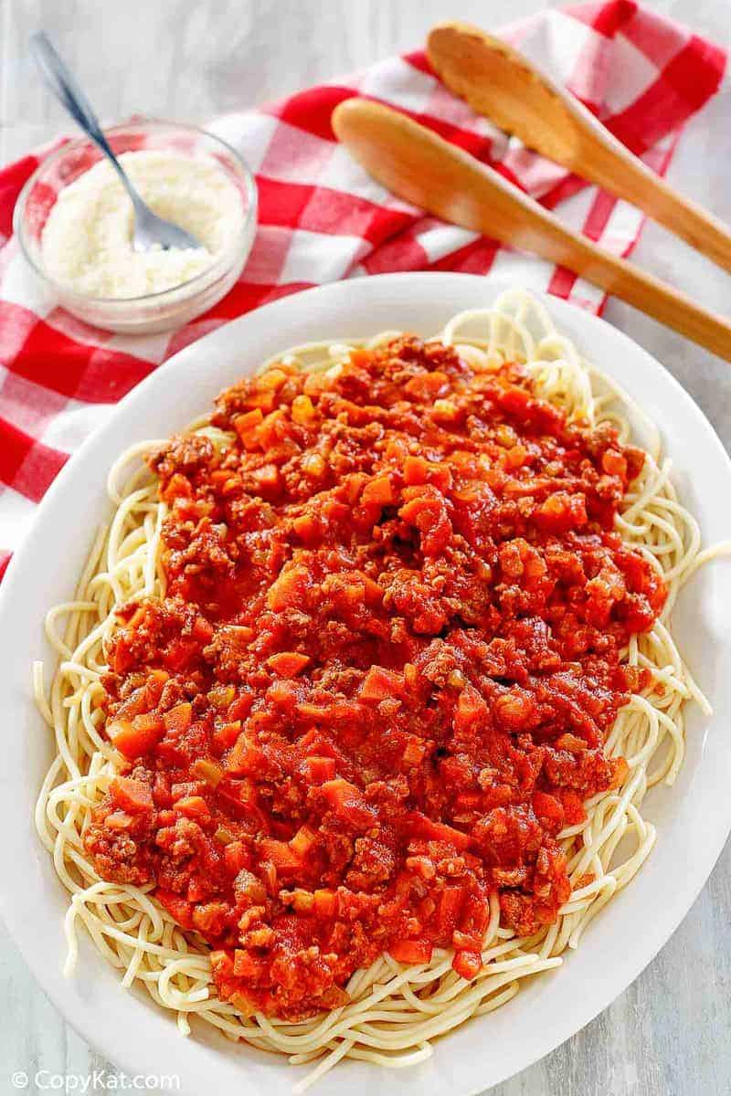 homemade Olive Garden Beef Bolognese over pasta on a platter