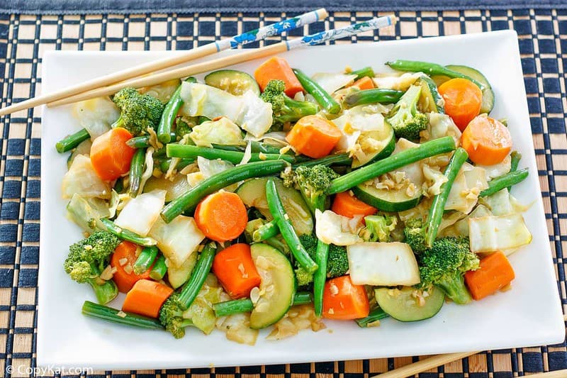 cooked broccoli, cabbage, carrots, green beans, and zucchini on a platter