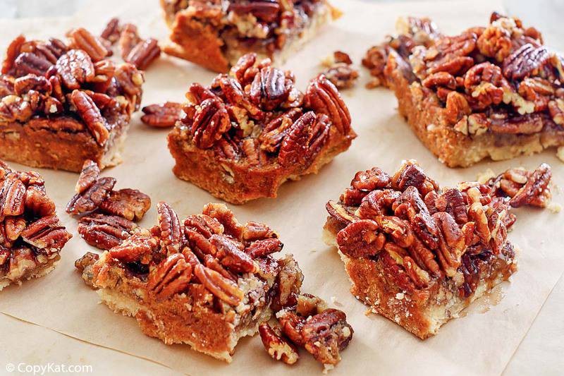 pecan pie bars with shortbread crust on parchment paper