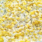 closeup photo of creamed corn in a blue baking dish