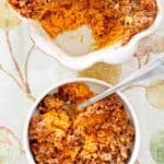 overhead view of sweet potato casserole with pecan topping in a bowl and baking dish