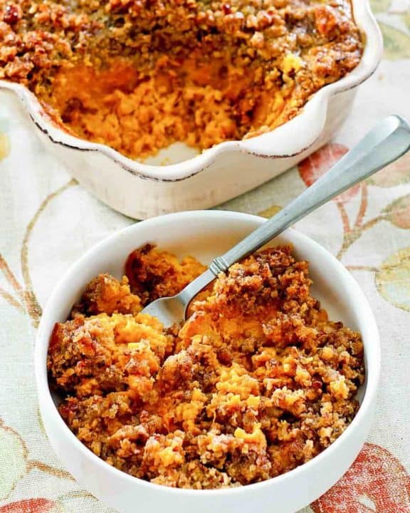 sweet potato casserole with brown sugar pecan topping in a bowl and baking dish