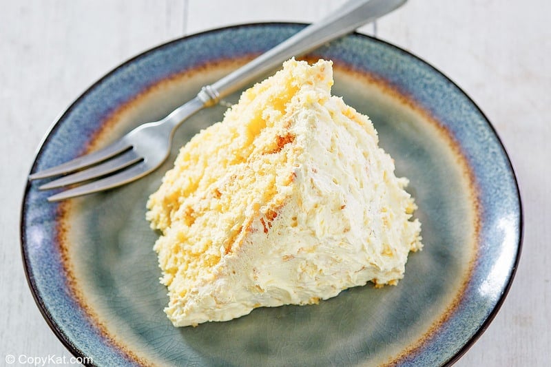 a slice of ambrosia cake and a fork on a plate