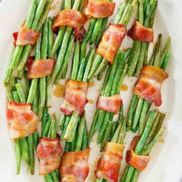 overhead view of bacon wrapped green bean bundles on a platter