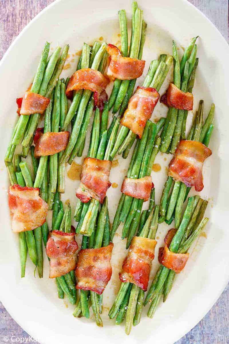 overhead view of bacon wrapped green bean bundles on a platter