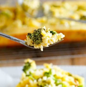 broccoli cheese rice casserole on a fork above a plate of it