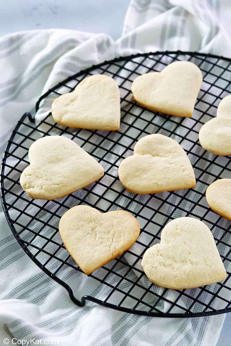 heart-shaped cake mix cookies on a round cooling rack