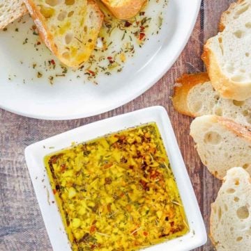 homemade Carrabba's Italian Butter Spicy Sicilian Dipping Sauce and bread slices