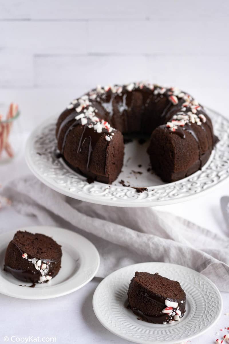 chocolate peppermint bundt cake on a cake stand and slices on plates