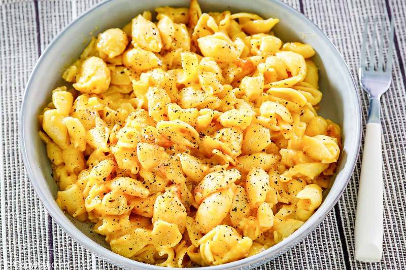 Instant pot macaroni and cheese in a bowl and a fork next to it