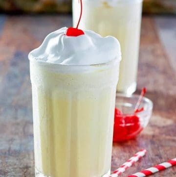 Homemade McDonald's eggnog shake with whipped cream and a cherry on top