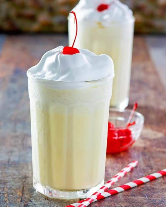Homemade McDonald's eggnog shake with whipped cream and a cherry on top
