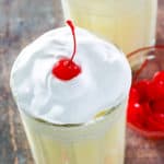 eggnog shake topped with whipped cream and a cherry