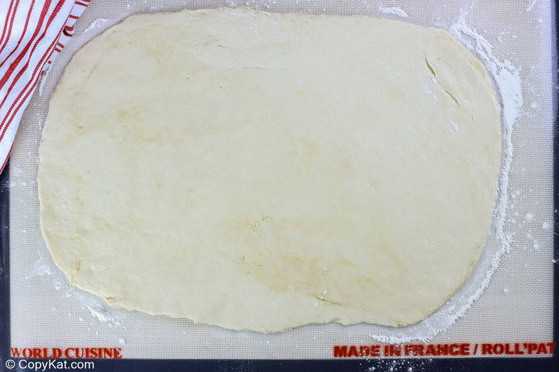 breadsticks dough rolled out on a floured mat