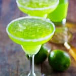 two Dewgarita cocktails and limes