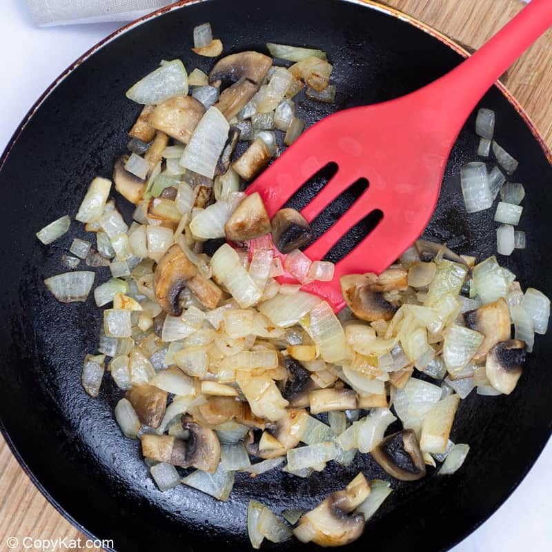 sauteed onions and mushrooms in a skillet