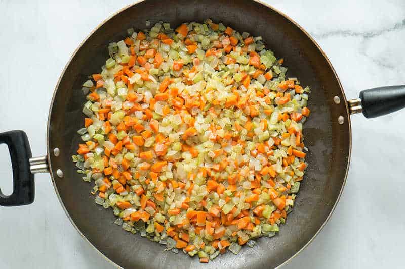 sauteed vegetables in a skillet for senate navy bean soup