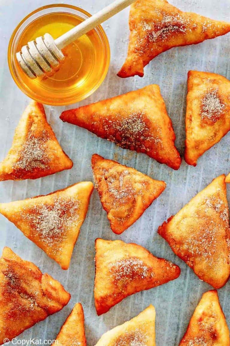 sopapillas and honey on parchment paper