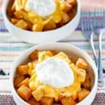 two bowls of homemade Taco Bell Cheesy Fiesta Potatoes bowls