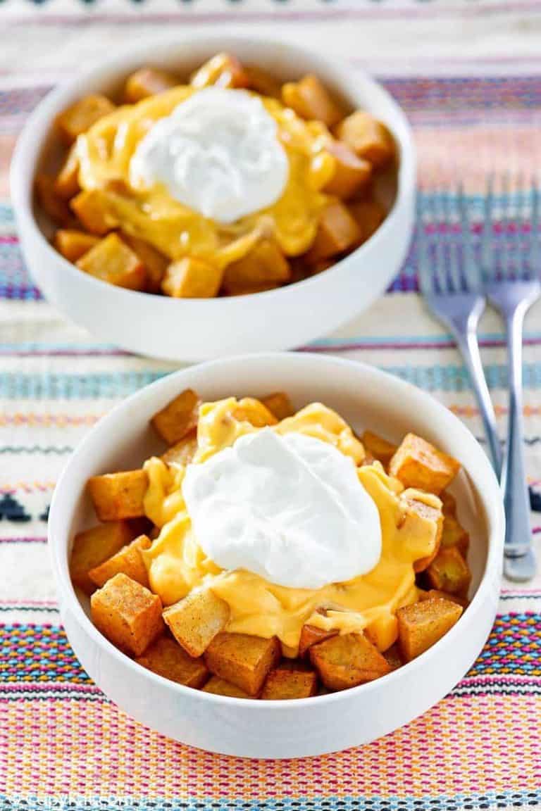 two bowls of homemade Taco Bell Cheesy Fiesta Potatoes bowls