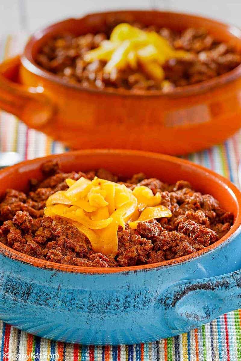 bowls of homemade Wick Fowler 2 Alarm Chili topped with cheese