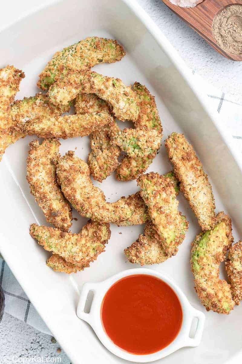 overhead view of air fryer avocado fries in a serving dish