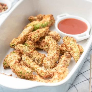 air fryer avocado fries and a bowl of ketchup in a serving dish