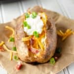 loaded air fryer baked potato on parchment paper