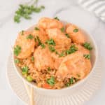 air fryer bang bang shrimp, sauce, and rice in a bowl