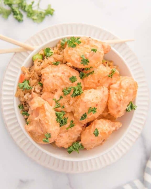 overhead view of bang bang shrimp, sauce, and rice in a bowl