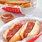 four baked hot dogs with barbecue sauce