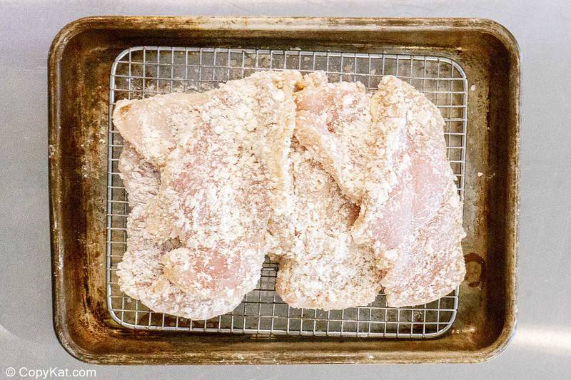 breaded chicken breasts on a wire rack