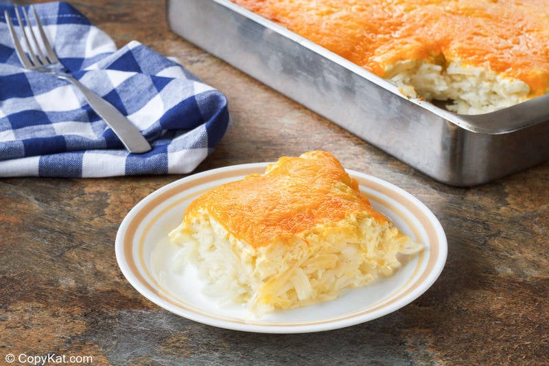 homemade Cracker Barrel hashbrown casserole on a plate and in a baking pan