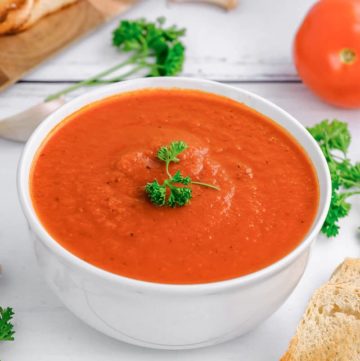 a bowl of Instant Pot Tomato soup and fresh parsley
